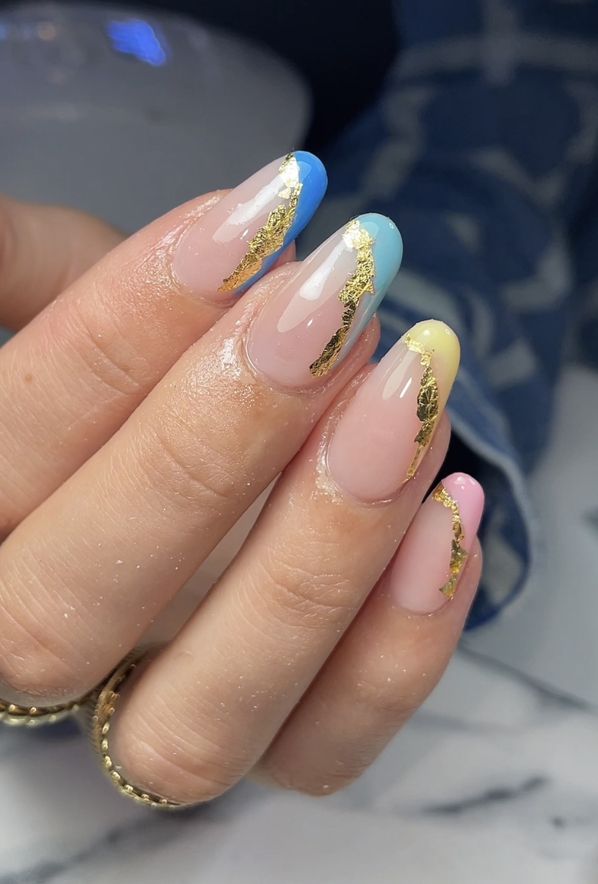 Amandelvormige nude nagels met gekleurde french en bladgoud